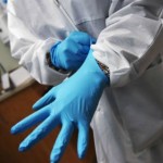 putting on dental exam gloves