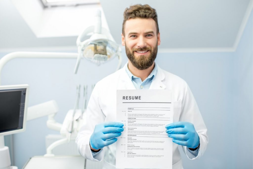 young dentist holding resume