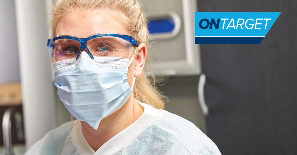 Dental hygienist in face mask and protective eyewear.