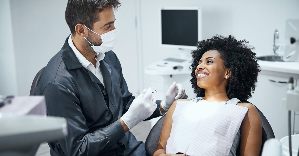 A dentist consults a patient.