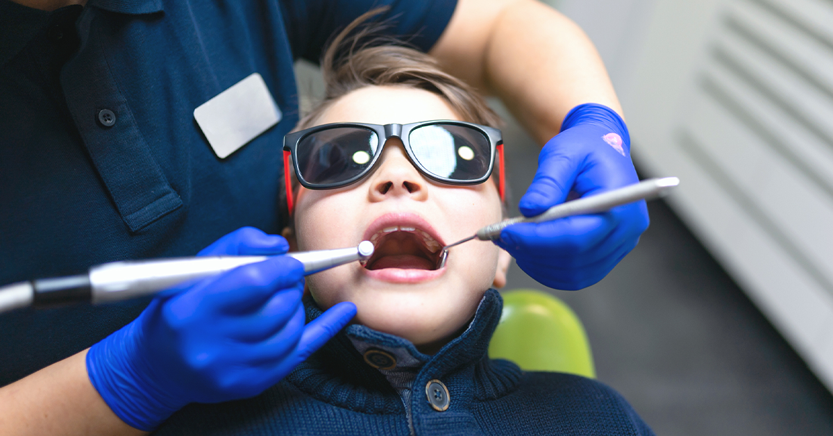 A pediatric dental patient getting his teeth cleaned.