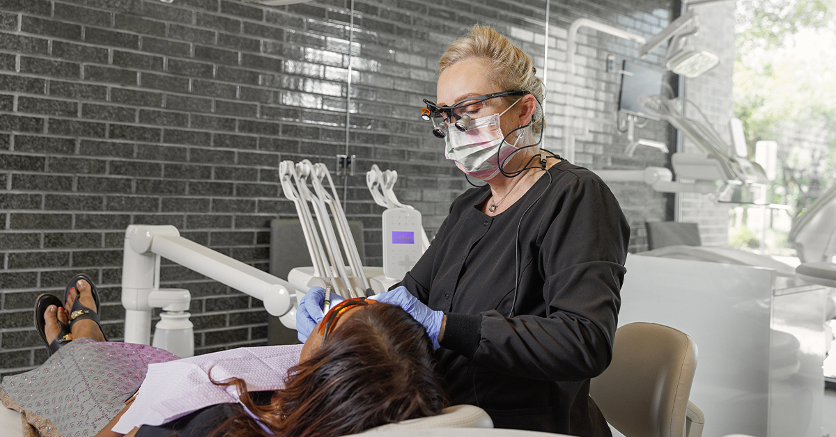 Beata A. Carlson, DDS, working on a patient.